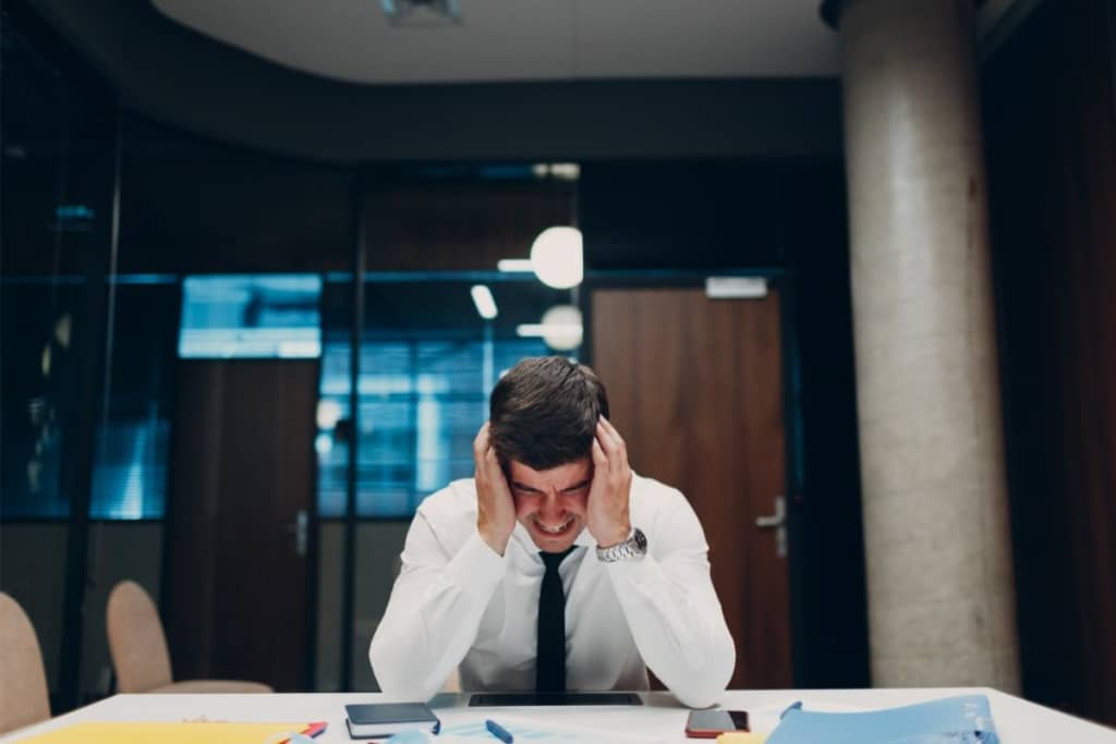 Homme en crise à son bureau.